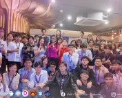 A large group photo of tech students and young professionals gathered indoors for the AWS Cloud Club - Celestia Supernova event. Around 40 participants are smiling, posing, and making hand gestures like peace signs and thumbs-up. The venue features modern lighting, warm wooden pillar accents, and a kitchen/lounge area in the background. The event branding "AWS Cloud Clubs Celestia" and "Celestial Supernova" is visible in the top corners, with partner logos and social media handles (AWS Cloud Club - Celestia and @awscloudclub_celestia) aligned along the bottom border.
